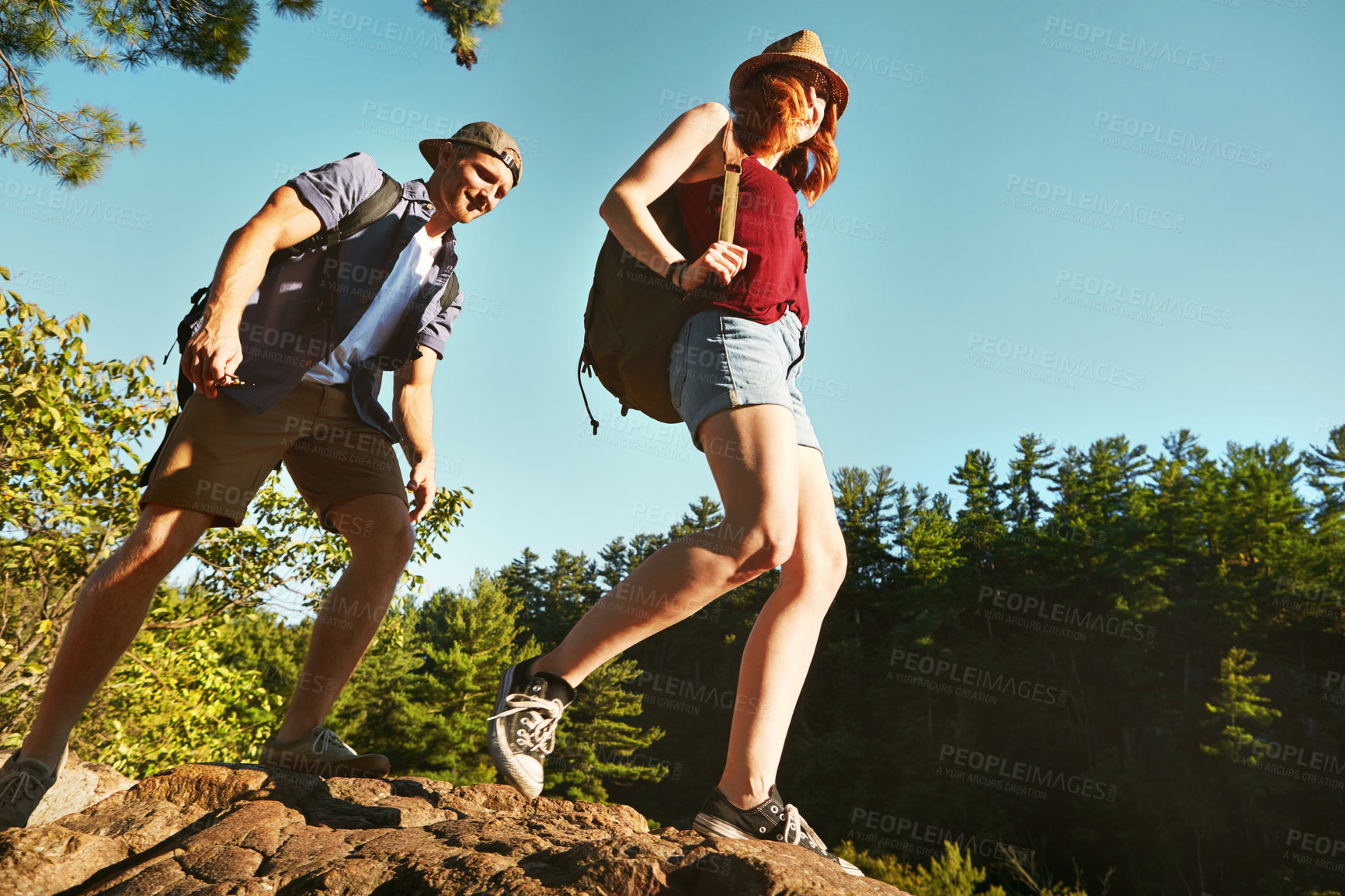 Buy stock photo Nature, hiking and couple walking with blue sky on adventure holiday in mountain, trees, and bush. Trekking, man and woman on happy travel vacation together in woods, forest or outdoor climbing park