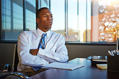 Buy stock photo Cropped shot of a businessman sitting thoughtfully in his office