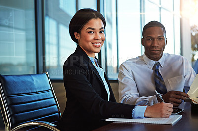 Buy stock photo Cropped portrait of two young businesspeople meeting in the boardroom