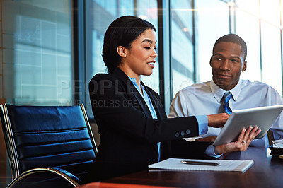 Buy stock photo Cropped shot of two young businesspeople meeting in the boardroom