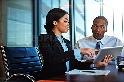 Buy stock photo Cropped shot of two young businesspeople meeting in the boardroom