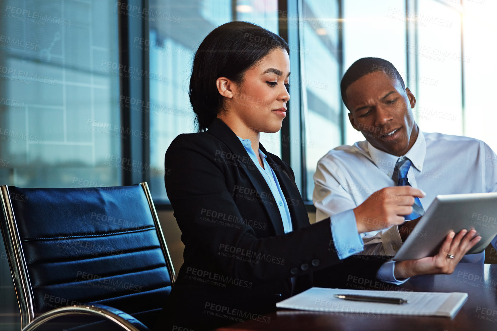 Buy stock photo Cropped shot of two young businesspeople meeting in the boardroom