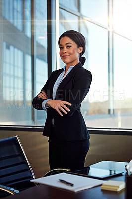 Buy stock photo Portrait of a young female lawyer standing by her desk in the office
