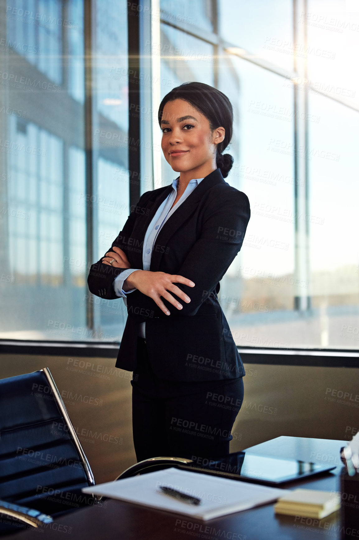 Buy stock photo Portrait of a young female lawyer standing by her desk in the office