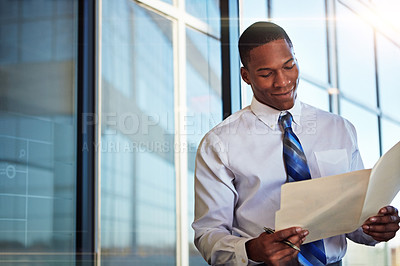 Buy stock photo Shot of a young male lawyer standing in his office