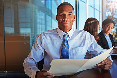 Buy stock photo Cropped portrait of a young businessman sitting in a meeting with her boardroom