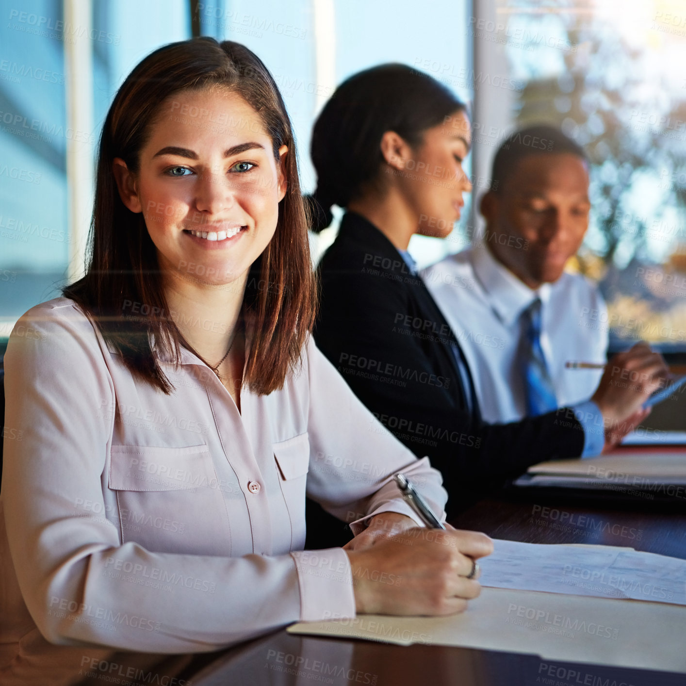 Buy stock photo Cropped portrait of a young businesswoman sitting in a meeting with her boardroom