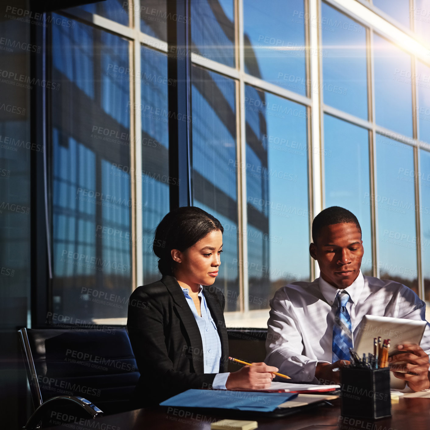 Buy stock photo Cropped shot of two young businesspeople meeting in the boardroom