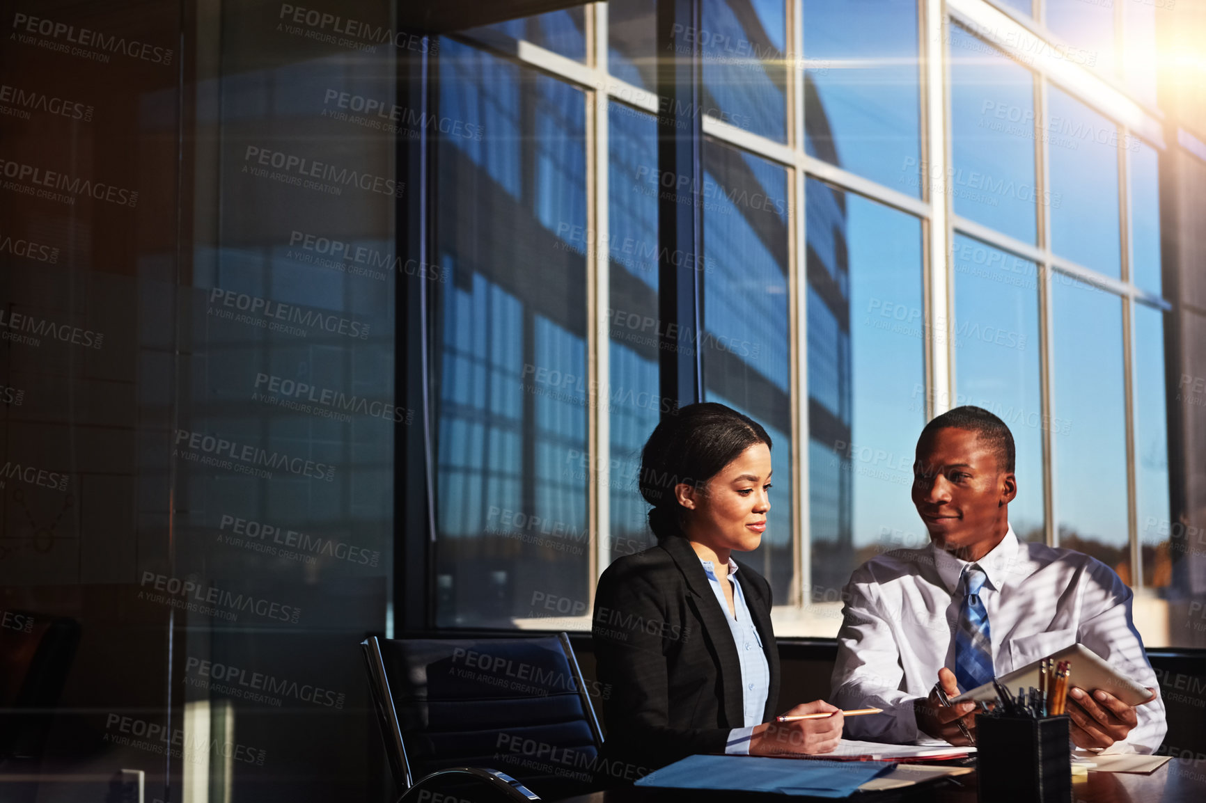 Buy stock photo Cropped shot of two young businesspeople meeting in the boardroom