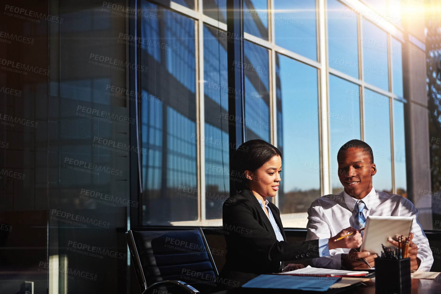 Buy stock photo Cropped shot of two young businesspeople meeting in the boardroom