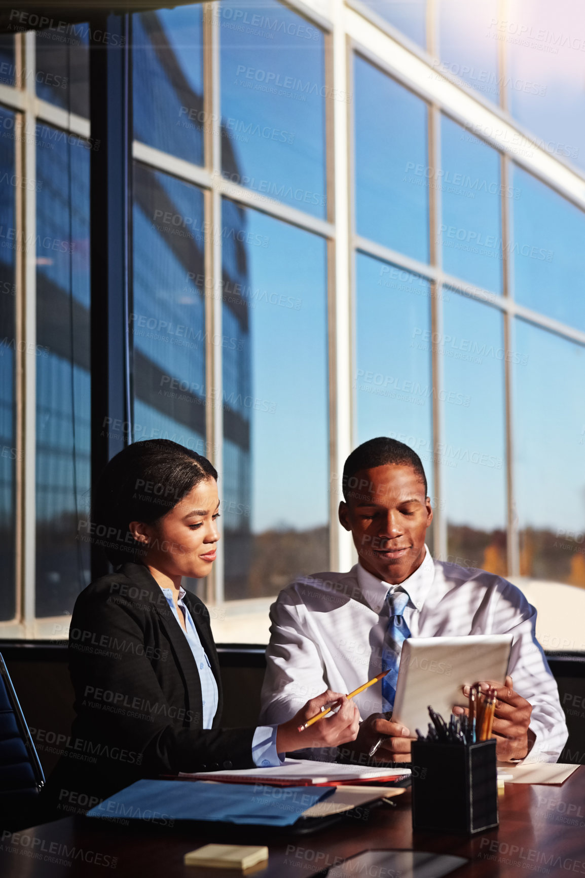 Buy stock photo Cropped shot of two young businesspeople meeting in the boardroom