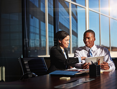 Buy stock photo Cropped shot of two young businesspeople meeting in the boardroom