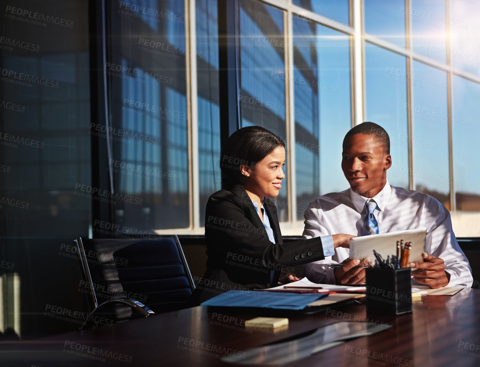 Buy stock photo Cropped shot of two young businesspeople meeting in the boardroom