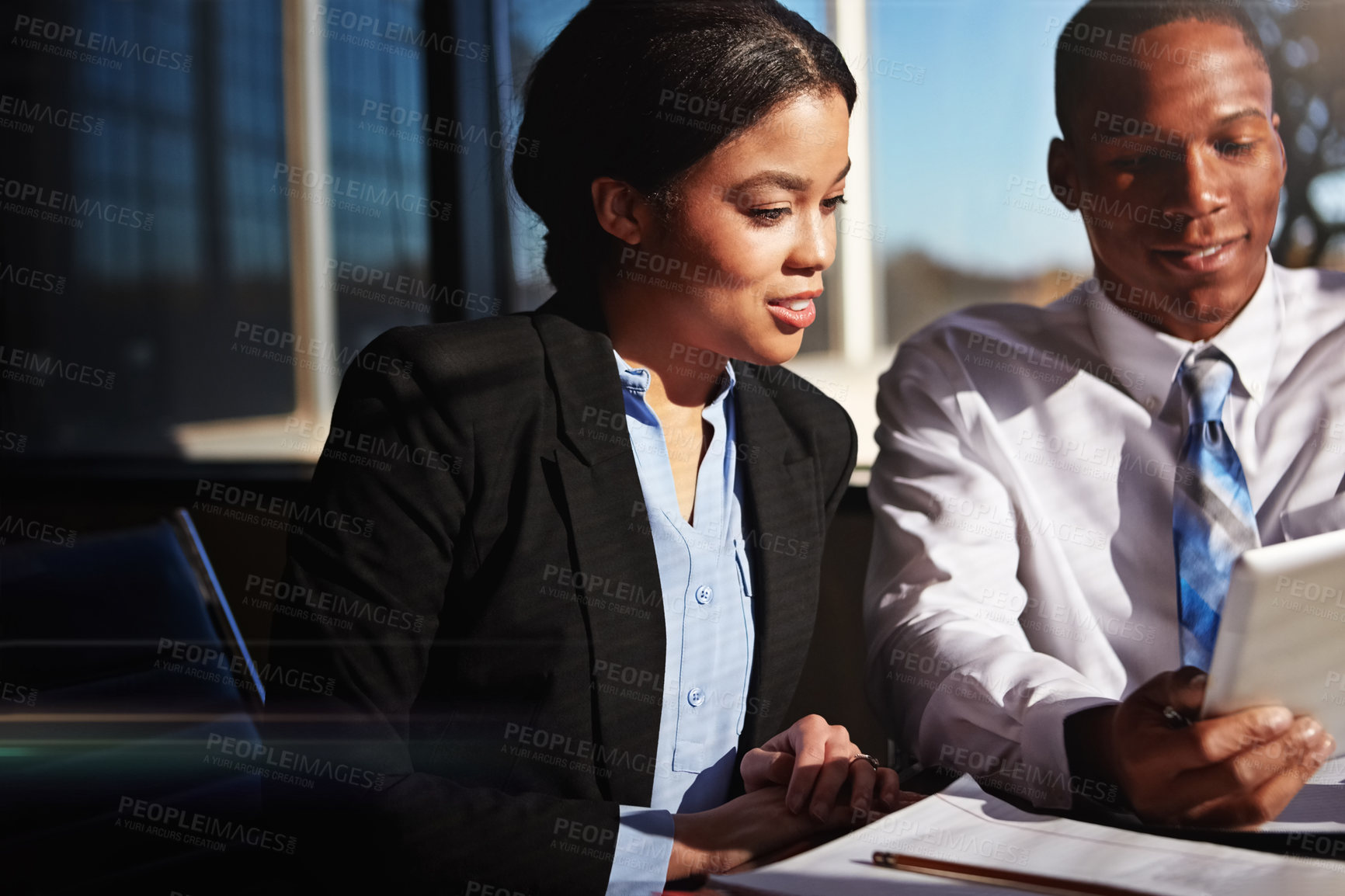 Buy stock photo Cropped shot of two young businesspeople meeting in the boardroom