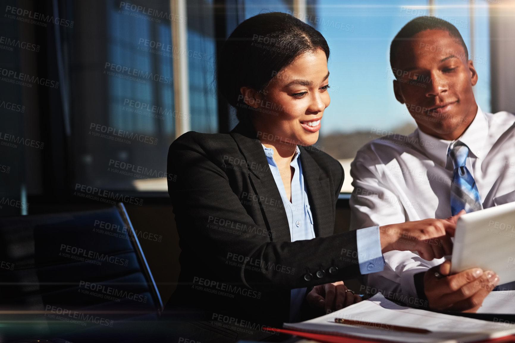 Buy stock photo Cropped shot of two young businesspeople meeting in the boardroom