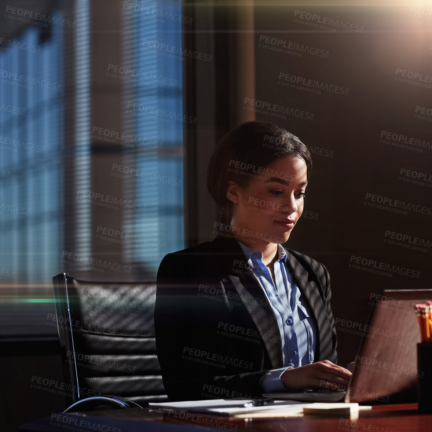 Buy stock photo Shot of a businesswoman using her laptop at her desk