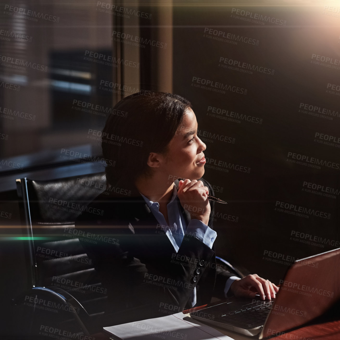 Buy stock photo Shot of a young woman contemplating while using her laptop