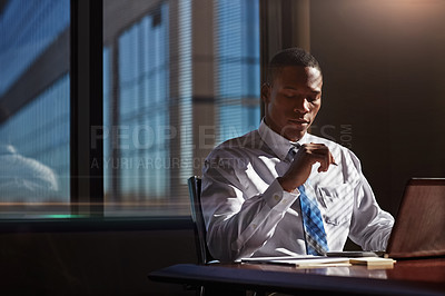 Buy stock photo Shot of a businessman using his laptop at his desk