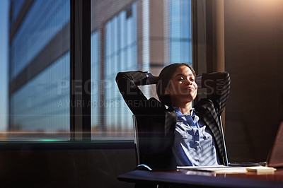 Buy stock photo Shot of a woman sitting back after a long day at the office