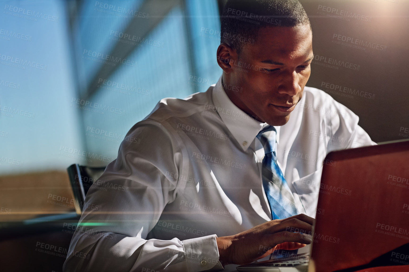 Buy stock photo Shot of a businessman using his laptop at his desk