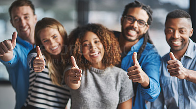 Buy stock photo Portrait of a group of creative businesspeople giving thumbs up while standing in their office