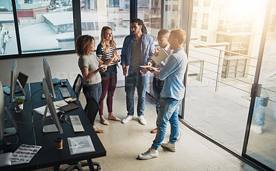 Buy stock photo High angle shot of a group of young designers talking in their office