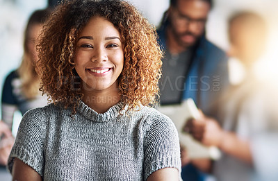 Buy stock photo Portrait of an attractive young designer standing in the office with her colleagues in the background