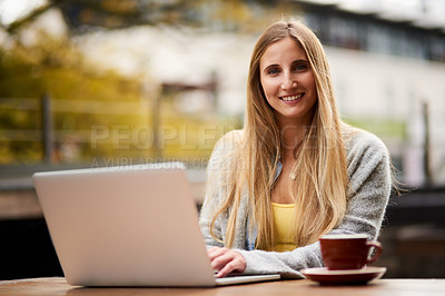 Buy stock photo Portrait of an attractive young woman using her laptop at an outdoor coffee shop