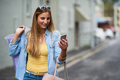 Buy stock photo Cropped shot of an attractive young woman out on a shopping spree in the city