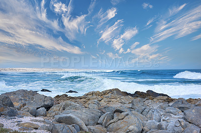 Buy stock photo Ocean, rocks and water in nature for landscape, environment and natural habitat creation. Blue sky, boulders or stone formation in seascape for travel, geology and sustainability on Australia horizon