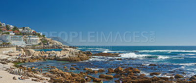 Buy stock photo Rocks, beach and ocean for travel, summer vacation or buildings in nature with mockup space on sky outdoor. Sea water, stones or waves in horizon with land for tourism, adventure and people on island