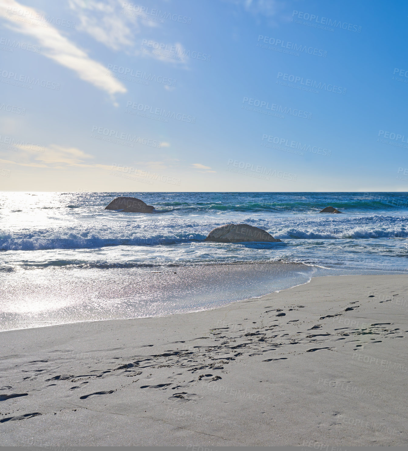 Buy stock photo Sand, beach and ocean coast for holiday, travel or vacation in nature with blue sky outdoor. Sea water, stones and waves in horizon with land for tourism, island or rocks with mockup space in Greece