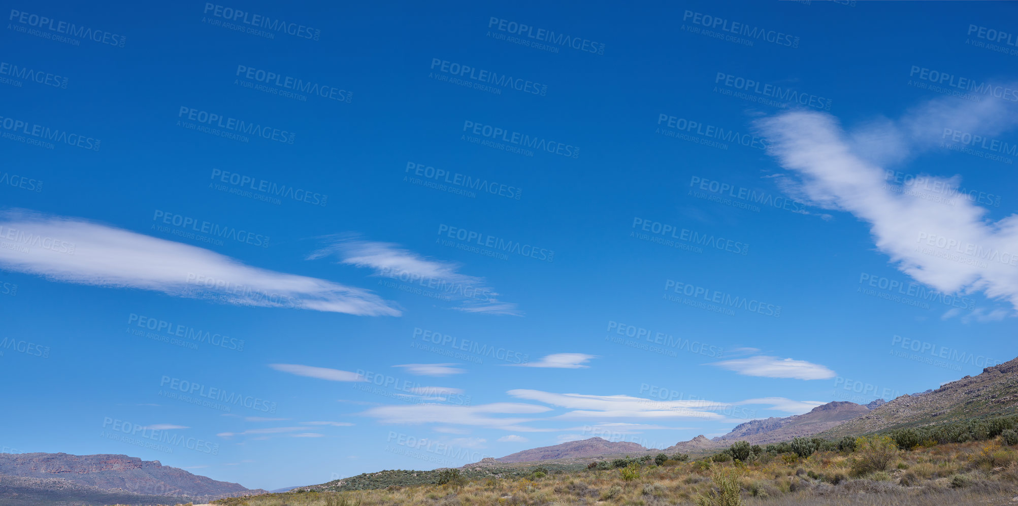 Buy stock photo Outdoor, blue sky and landscape of mountains in nature or remote location for sustainability. Natural, clouds and wilderness to explore on vacation, adventure and environment for travel in summer