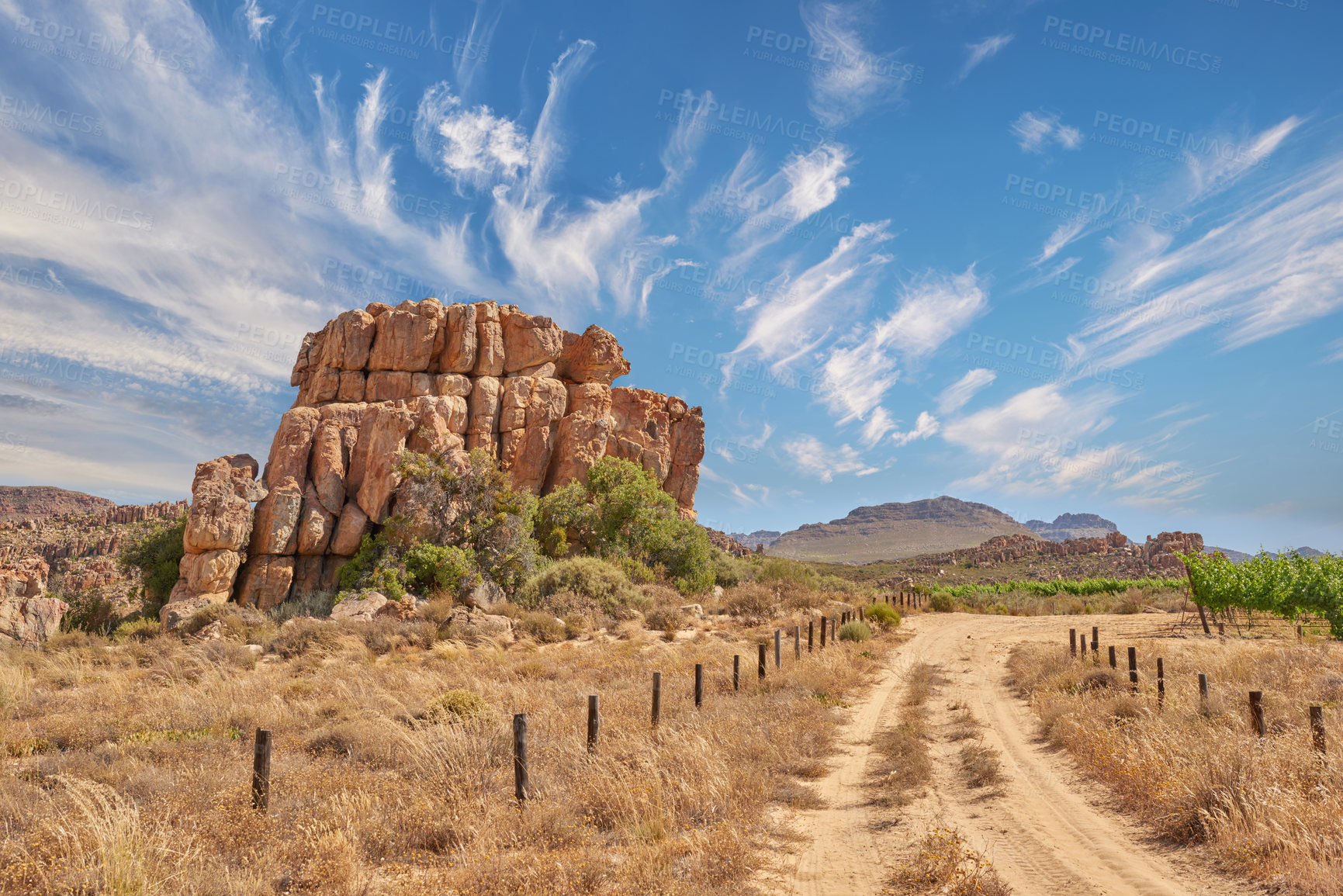 Buy stock photo Nature, road and sky with rock, formation and geology at location, bush or clouds in countryside. Countryside, stone and gravel path at conversation park, field or mountains with outcrop in Australia