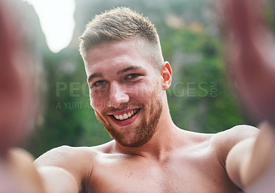 Buy stock photo Portrait of a handsome young man taking a selfie outside