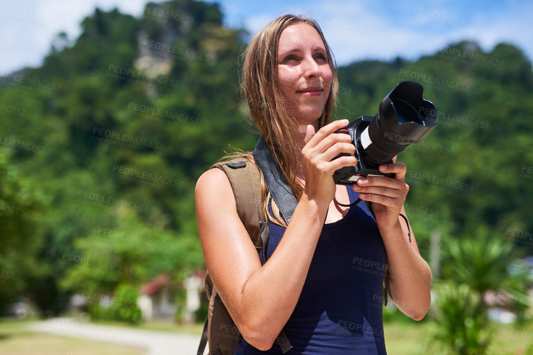 Buy stock photo Cropped shot of a young woman taking photographs outside