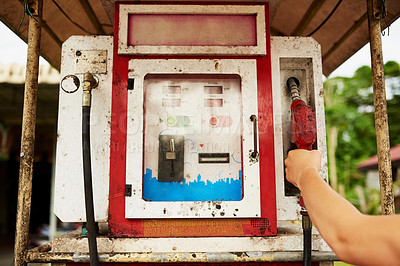 Buy stock photo Cropped shot of a man using an old pump at a gas station