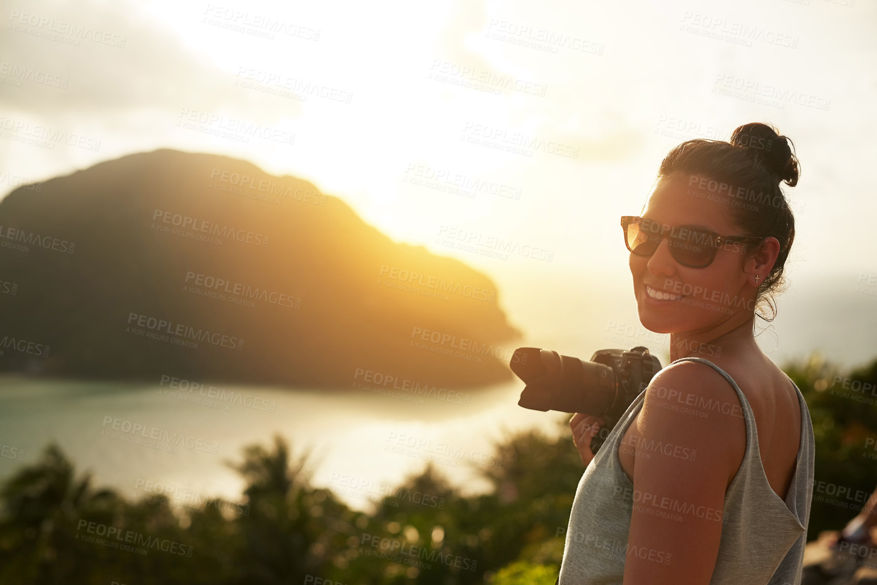 Buy stock photo Portrait of a happy young woman photographing a tropical view while on holiday