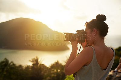 Buy stock photo Shot of a young woman photographing a tropical view while on holiday