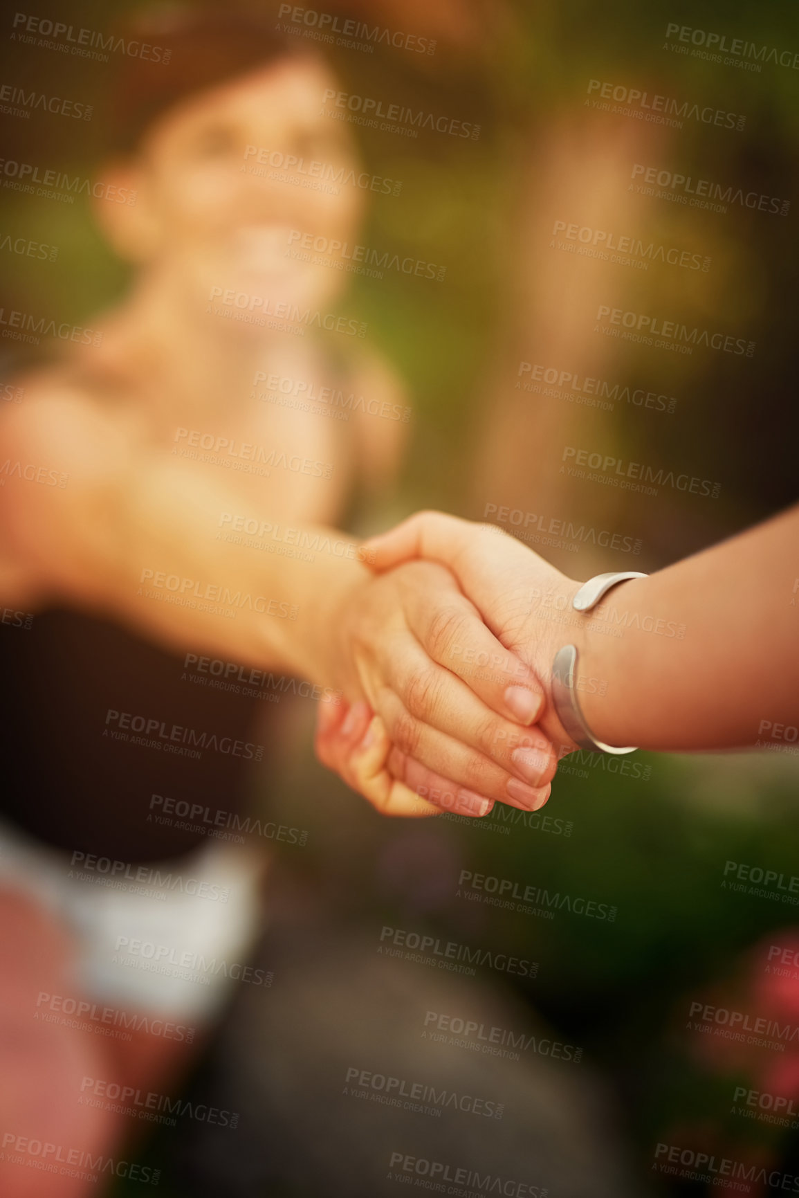 Buy stock photo Shot of a young woman being led by the hand while exploring outside