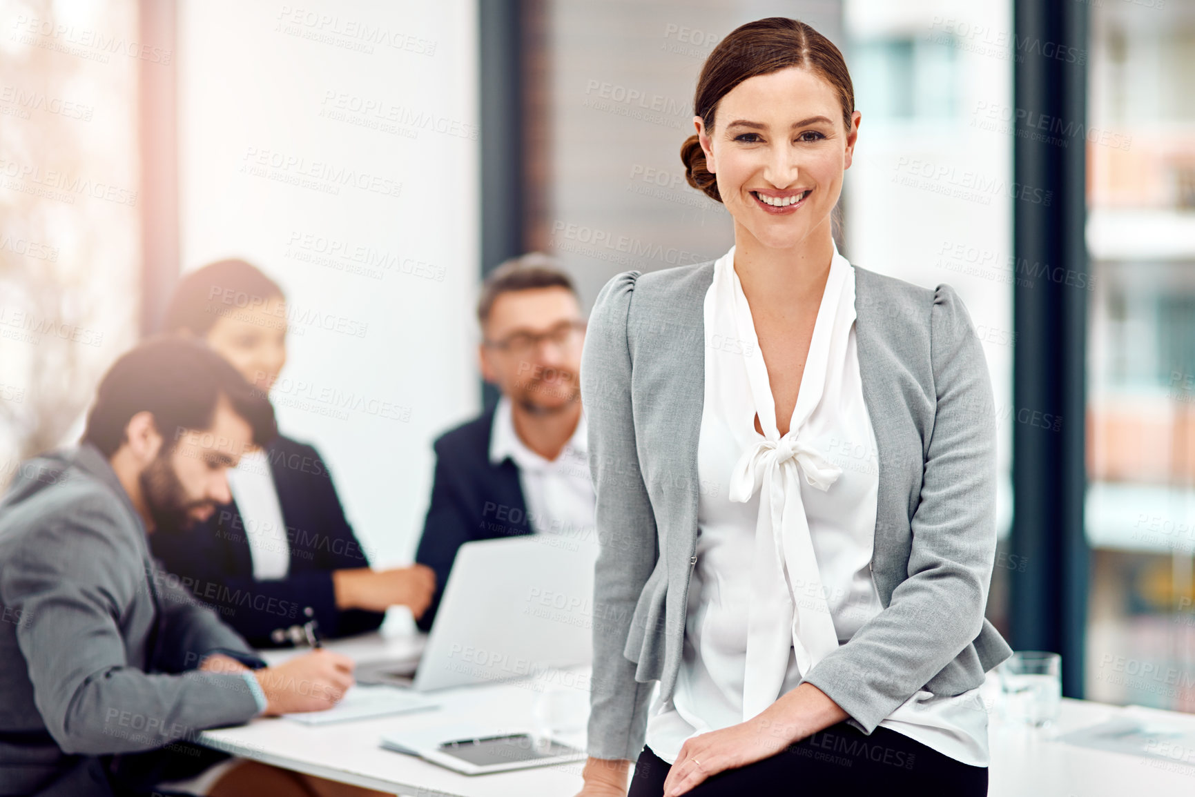 Buy stock photo Portrait of a businesswoman in the office with her colleagues in the background