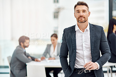 Buy stock photo Portrait of a businessman in the office with his colleagues in the background