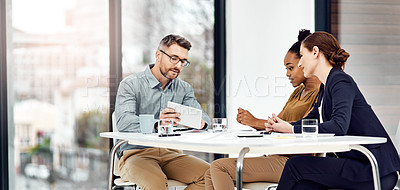 Buy stock photo Cropped shot of three businesspeople working together in their office