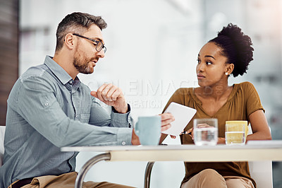 Buy stock photo Cropped shot of two businesspeople working together in their office