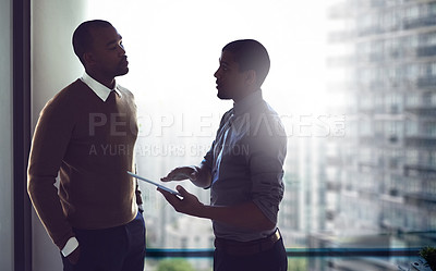 Buy stock photo Cropped shot of two businessmen having a discussion in an office