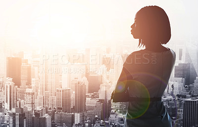 Buy stock photo Rearview shot of a young businesswoman looking out from a large window in the office