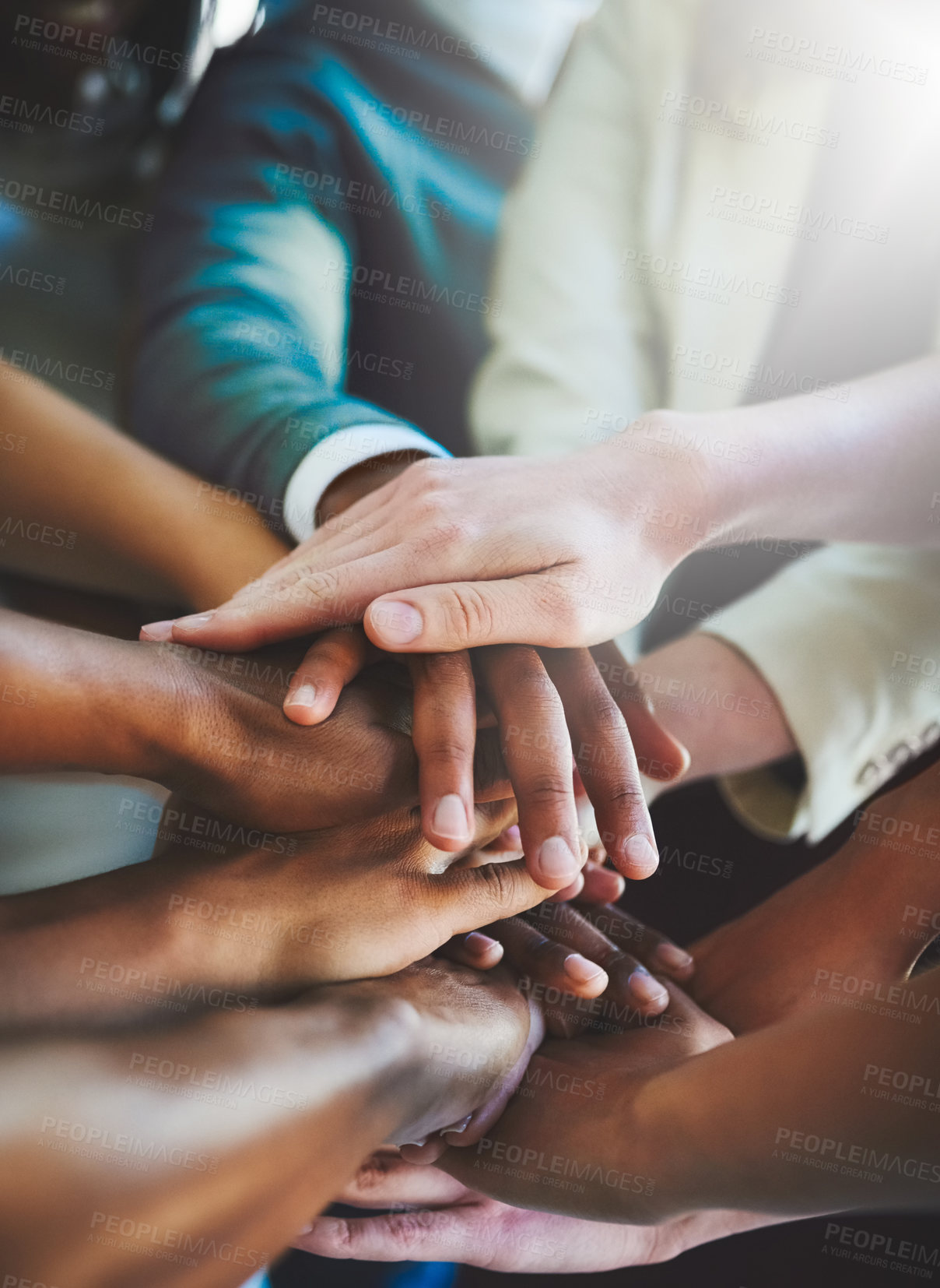 Buy stock photo Cropped shot of a group of businesspeople piling their hands on top of each other