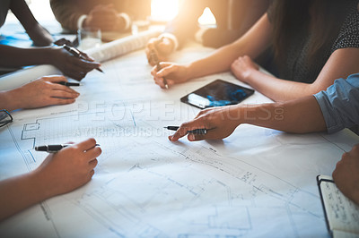 Buy stock photo Architect working with a team or group, looking over plans or blueprints and talking about architecture and development. Hands on paper work with a group meeting in the boardroom to discuss building