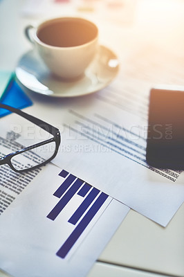 Buy stock photo Closeup shot of a cup of coffee, spectacles and paperwork on an office desk