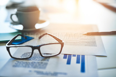 Buy stock photo Closeup shot of spectacles and paperwork on an office desk